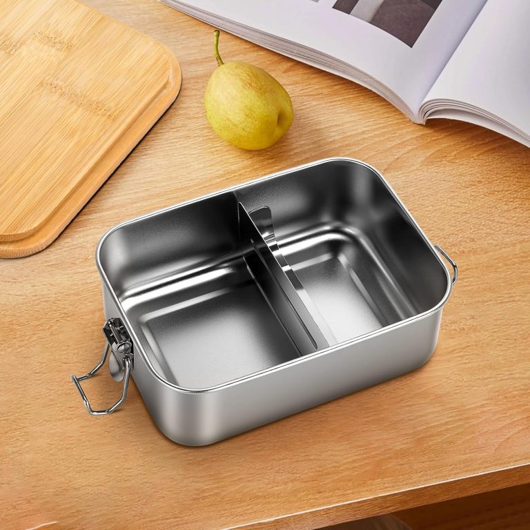 Empty stainless steel lunch box with a metal divider creating two sections and its bamboo lid set aside