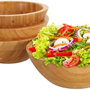 Four bamboo salad bowls with three stacked bowls and one filled with salad