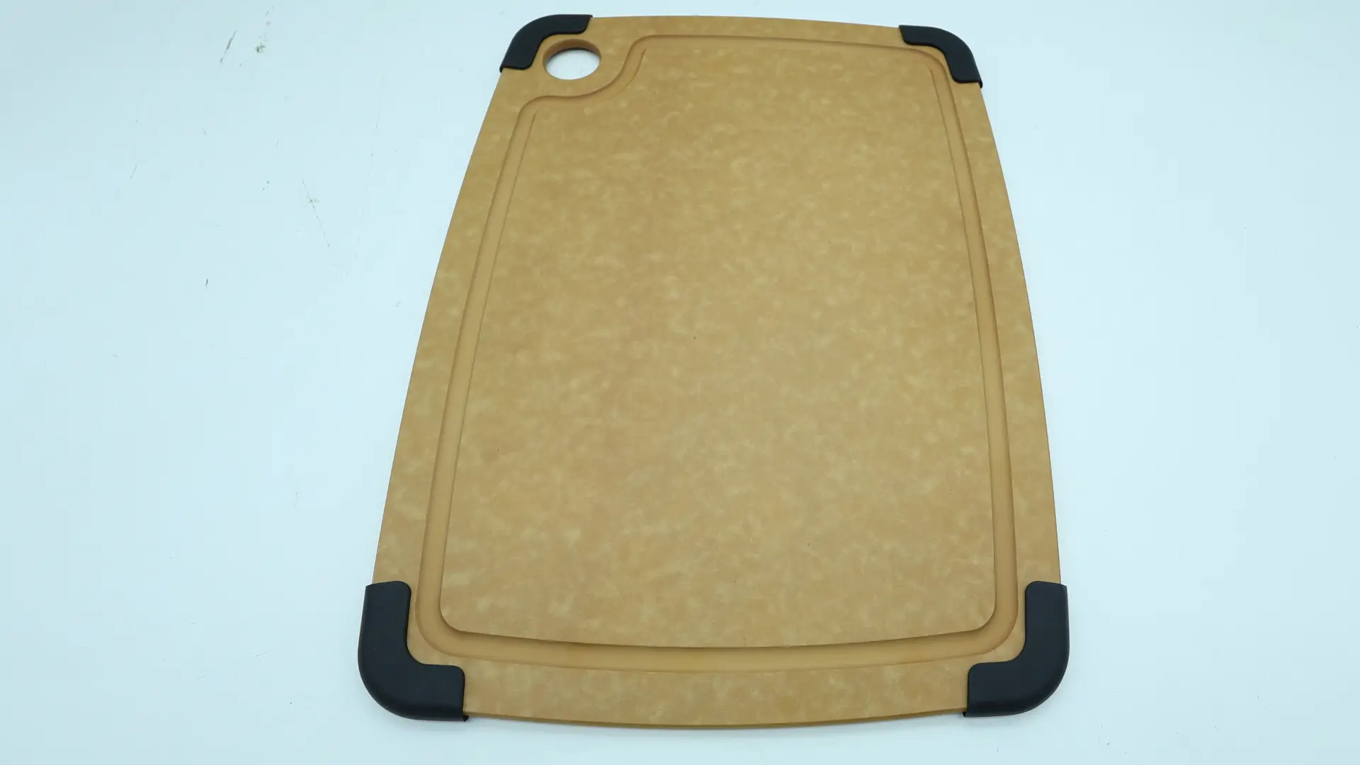 Wood fiber cutting boards stored vertically in a ventilated kitchen rack