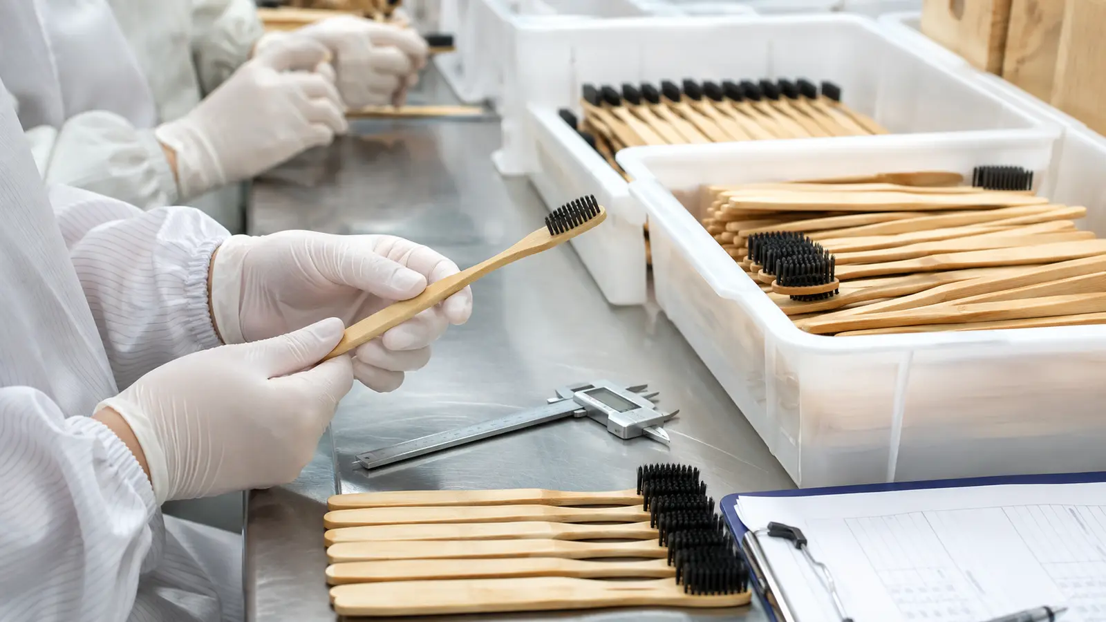 Bamboo toothbrush manufacturer inspecting handle finish and bristle quality