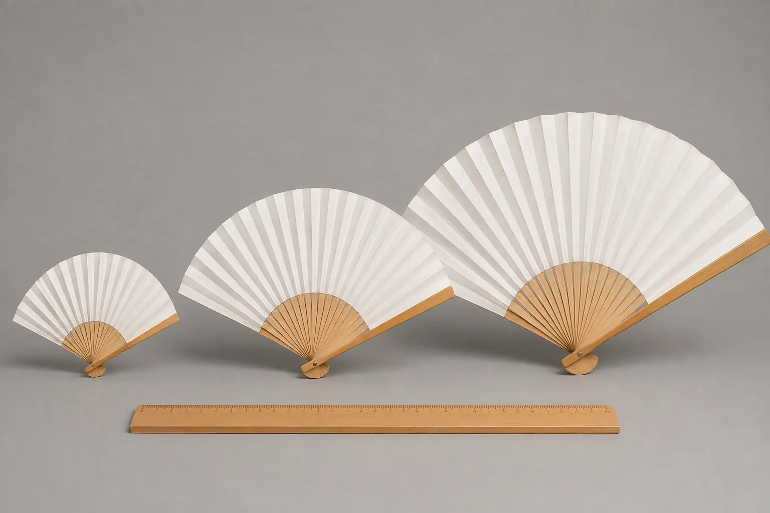 Mini, standard and large bamboo hand fans compared with proportionally sized staves and paper leaves