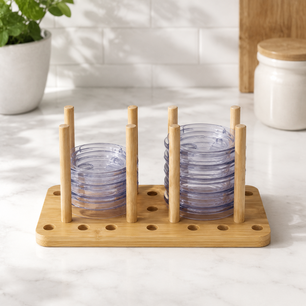 Bamboo Tumbler Lid Organizer – Kitchen Counter View Adjustable bamboo tumbler lid organizer holding two stacks of unbranded cup lids on a kitchen counter