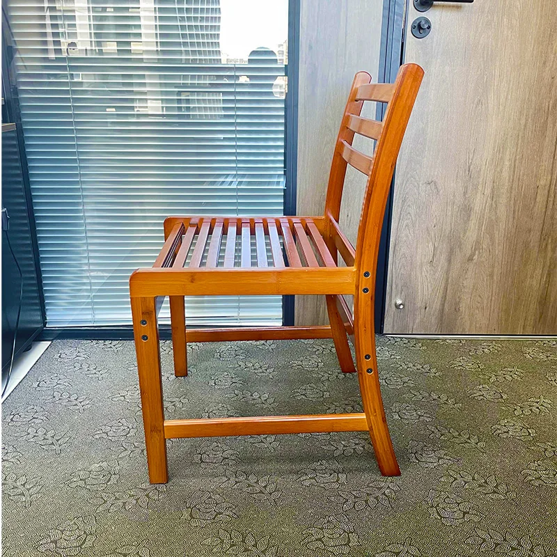 Side view of a bamboo chair showing the slatted seat, angled backrest, stretchers, and fasteners.