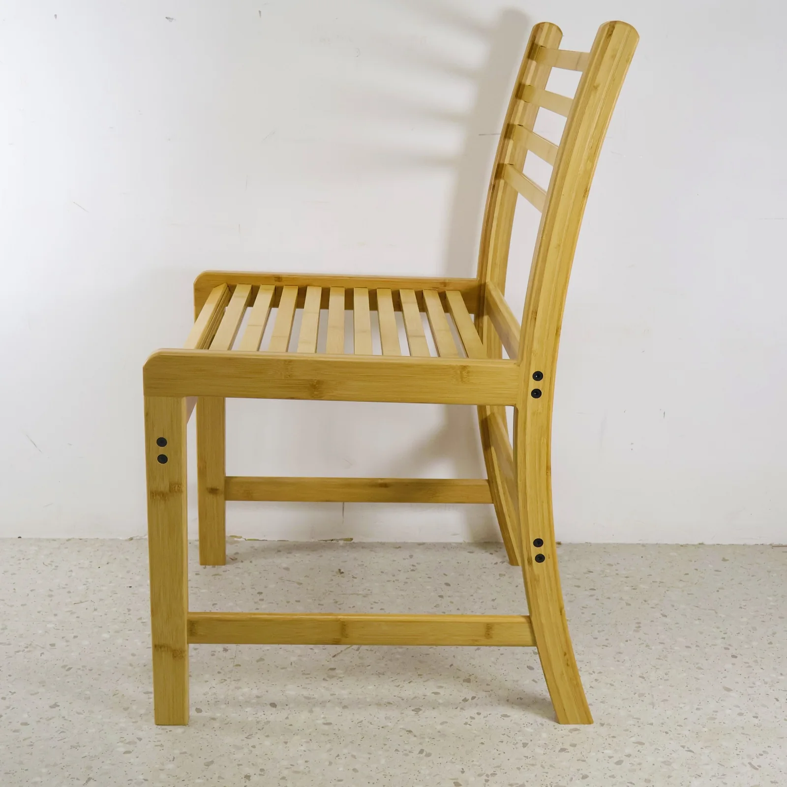 Side view of an adult-size natural bamboo dining chair used as a design reference.