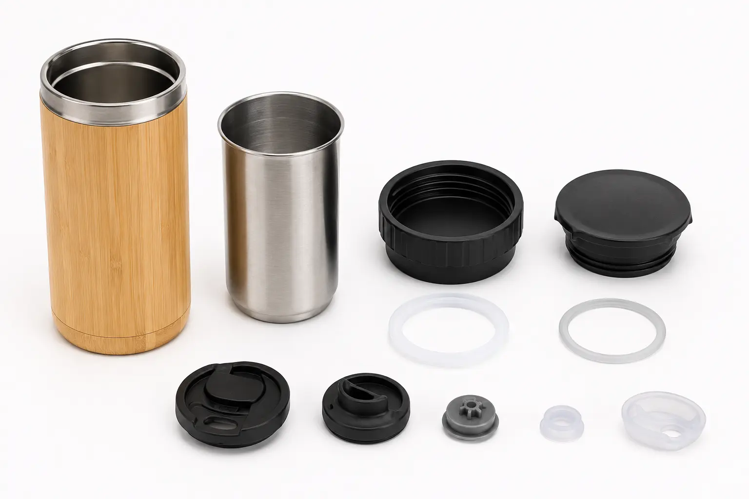Bamboo travel mug lid, gasket and drinking components arranged for review