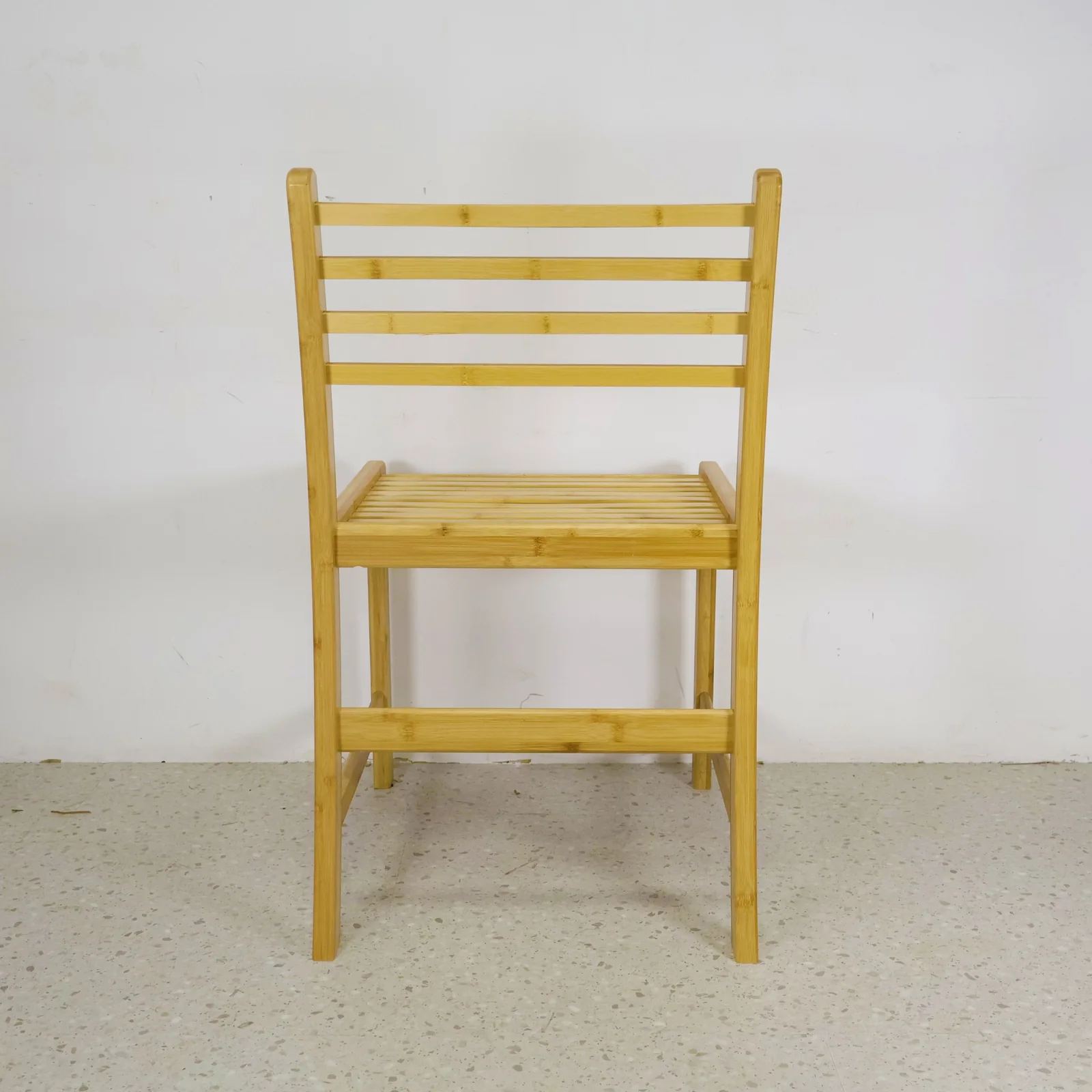Front view of an adult-size natural bamboo chair used for proportion comparison.